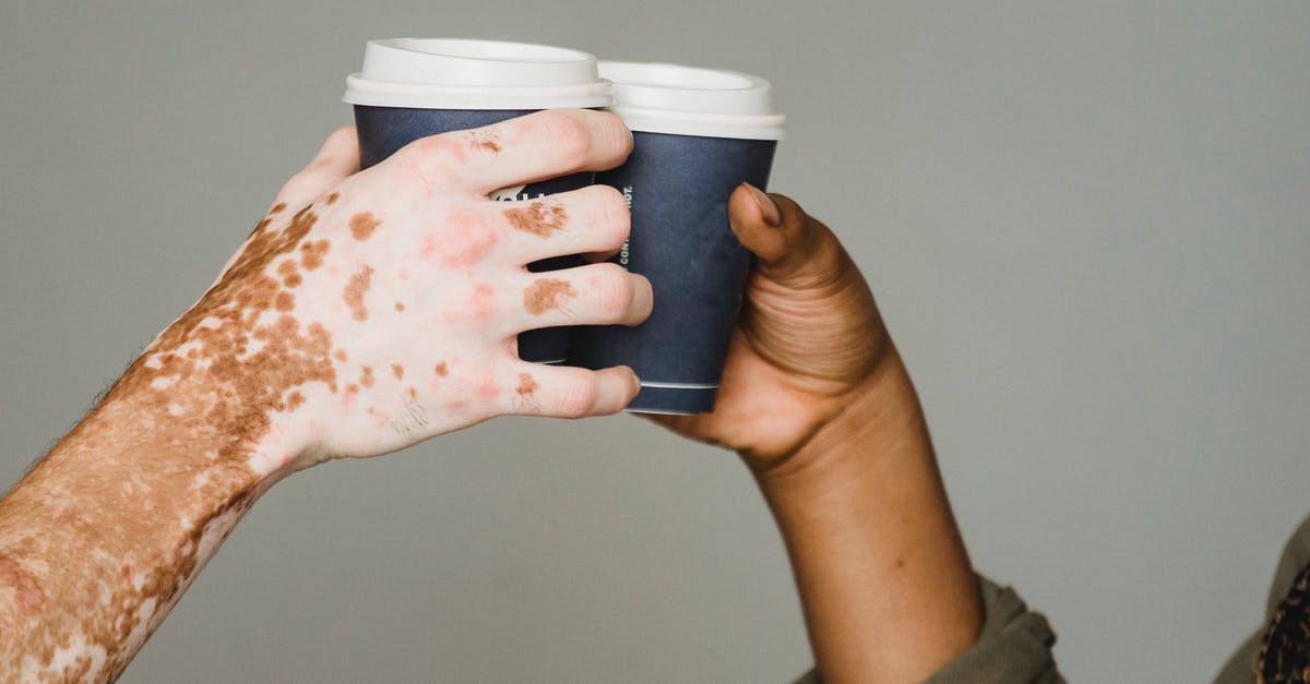 COUNTRSTRIKE GO config & skins - Unrecognizable man with vitiligo skin and anonymous African American male clinking with hot drinks on gray background during coffee break