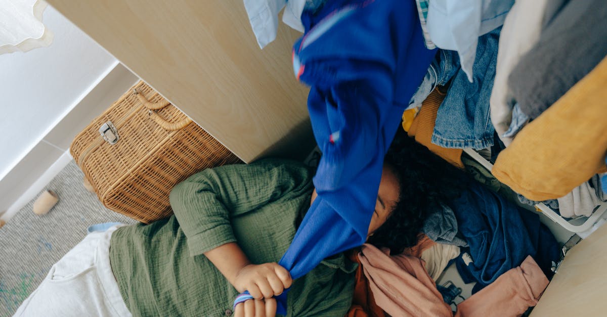 Craftbook - Sort Potions - Anonymous black girl lying on stack of clothes in bedroom