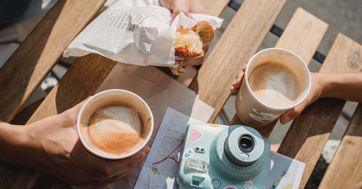 CS GO vote map with custom map list - From above of crop anonymous couple with disposable glasses of cappuccino and photo camera on table in street cafeteria