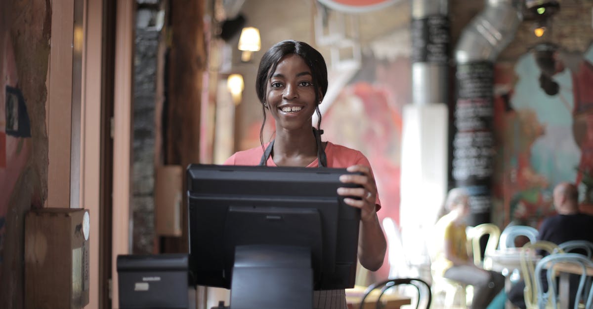 Custom armor stand name with multiple lines - Positive young woman in uniform smiling while standing at counter desk in  cafe