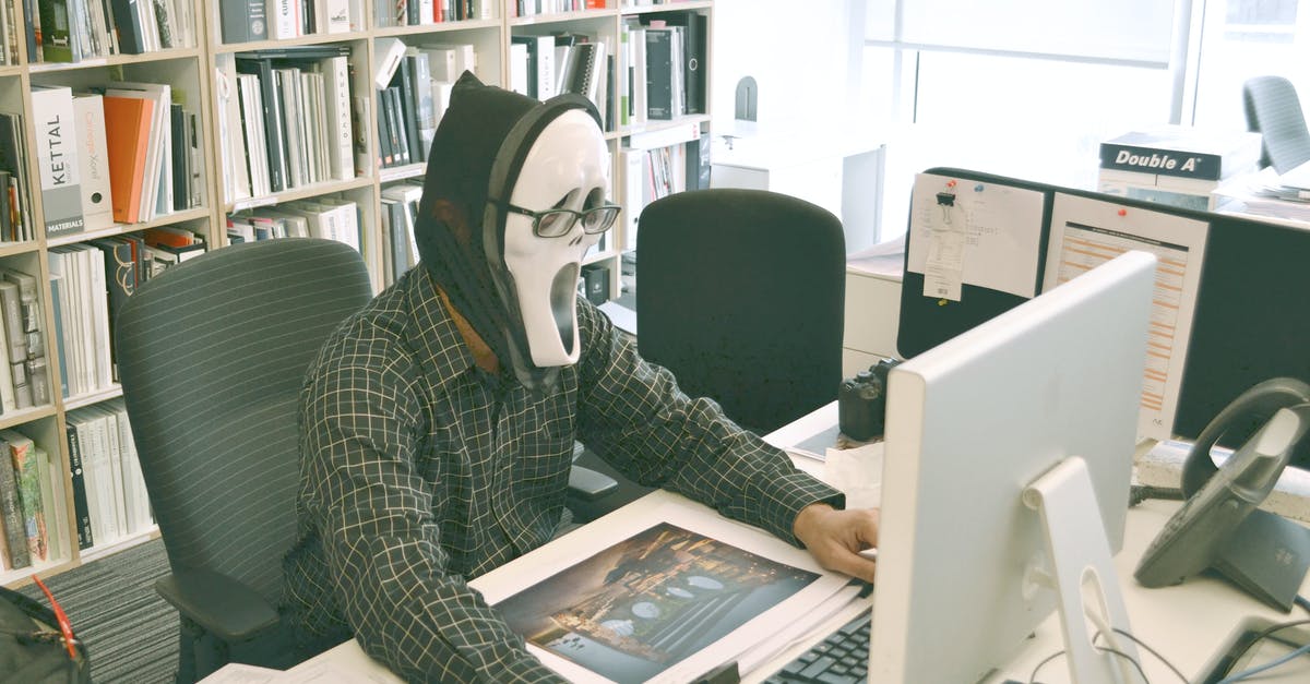 Desktop Windows Manager causes severe game lag - Person Wearing Scream Mask and Black Dress Shirt While Facing Computer Table during Daytime