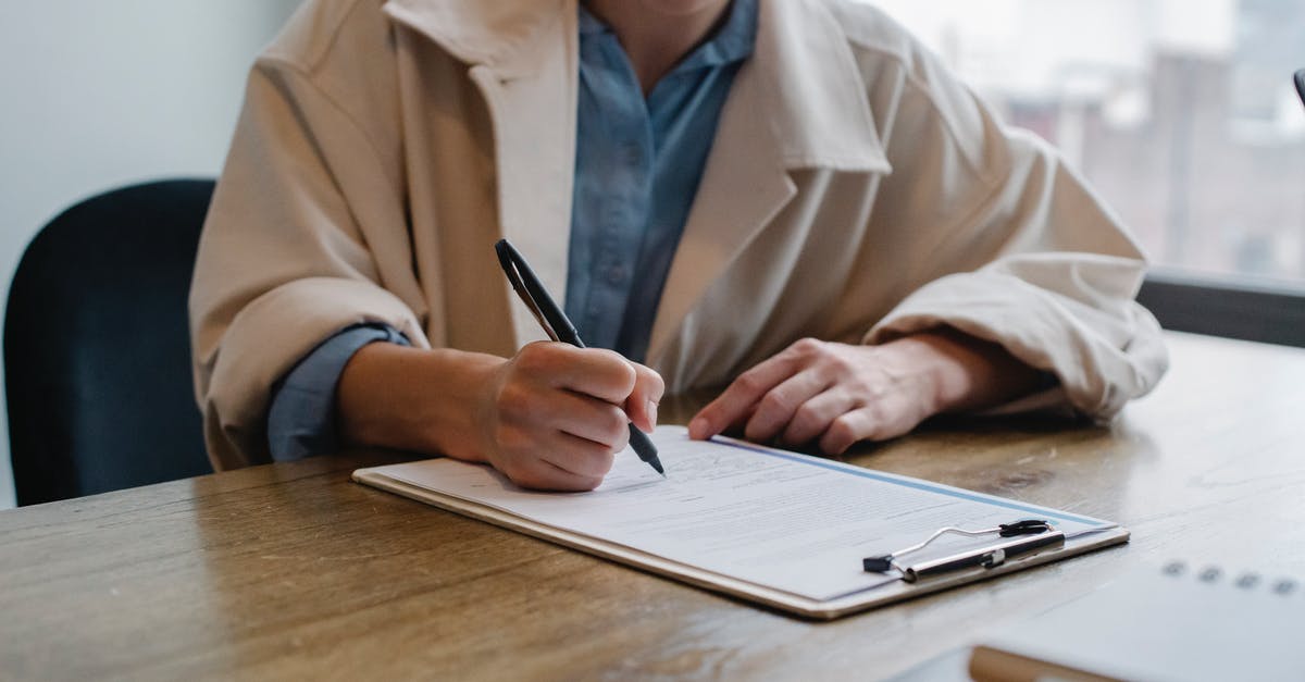 Diablo 3: Question about alternative gear choices - Focused woman writing in clipboard while hiring candidate