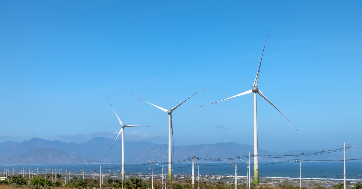 Difference between the PS4 and GoG version of Mount and Blade? - Scenery view of wind turbines in row on terrain with plants against ocean and mounts in daytime