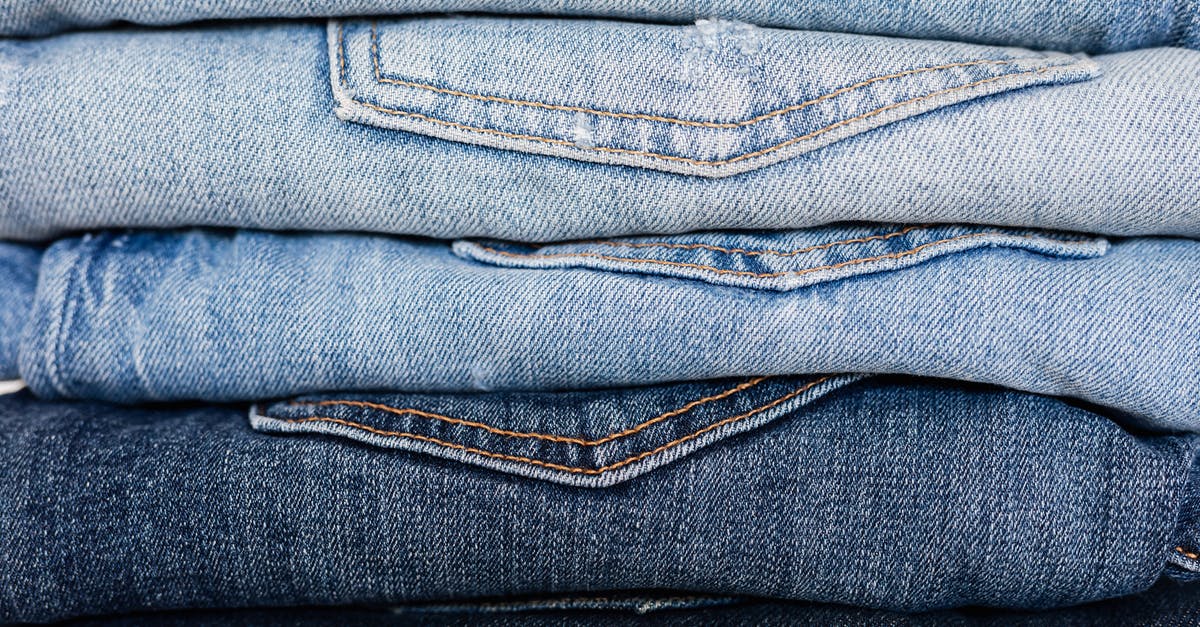 Different commands select different entities (with the same target selector) - Closeup of stack of blue denim pants neatly arranged according to color from lightest to darkest