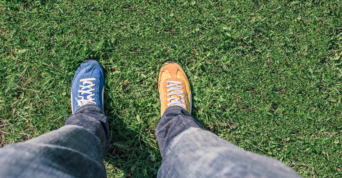 Difficulty Differences - Person Wearing Unpaired Running Shoes Standing on Green Grass