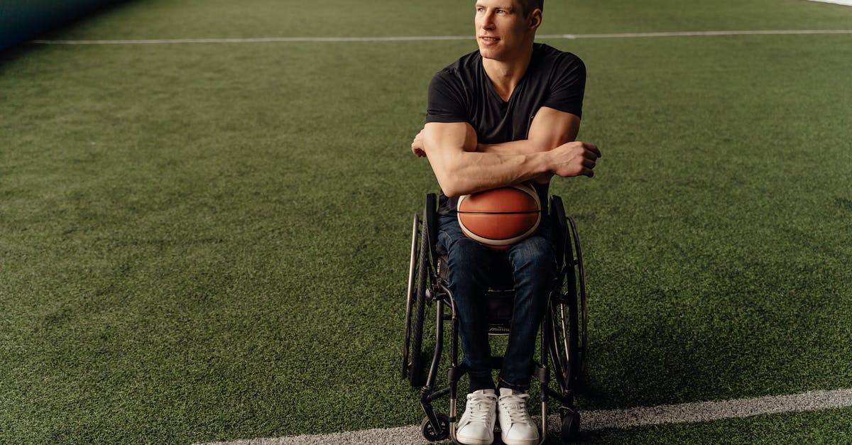 Disable player falling - A Man Sitting on a Wheelchair while Holding a Ball