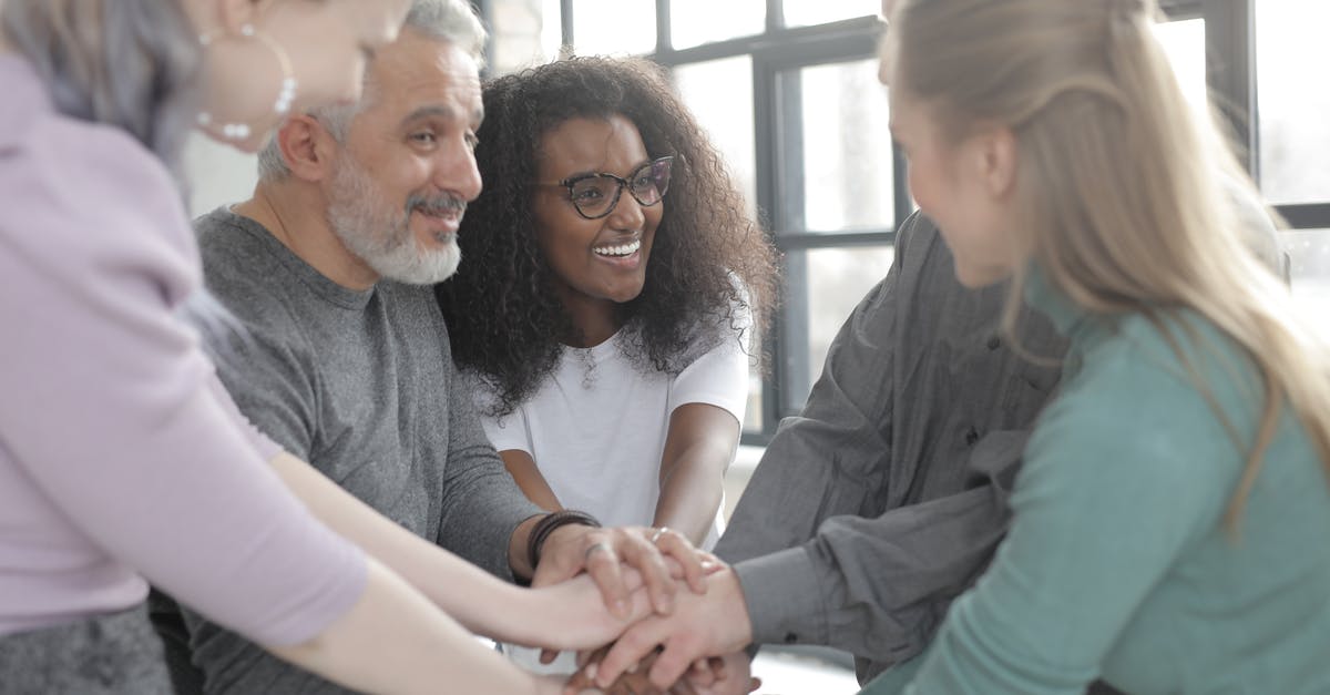 Discord-Minecraft integration - Content multiethnic colleagues joining hands after coming to agreement