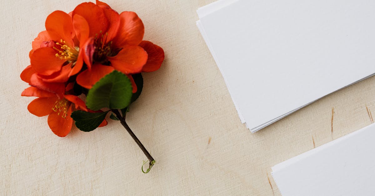 Do battle card effects stack? - Blank white visiting cards and red flower on wooden table