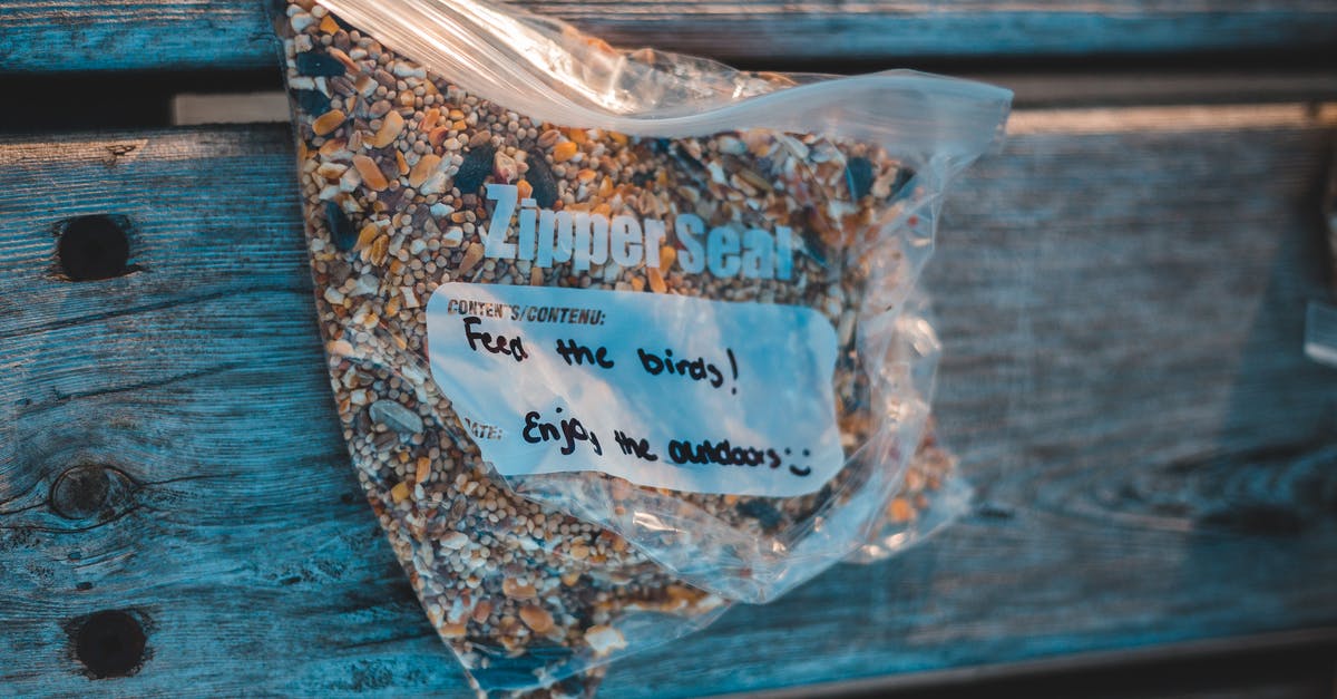 Do citizens want different kind of parks? - From above of transparent plastic zipper bag with bird feed and titles on wooden plank