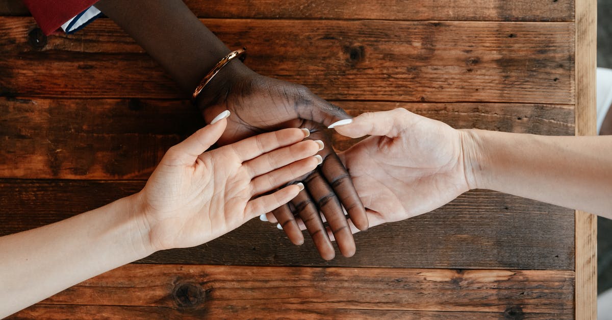 Do fade touched enchantments stack? - Diverse women stacking hands on wooden table