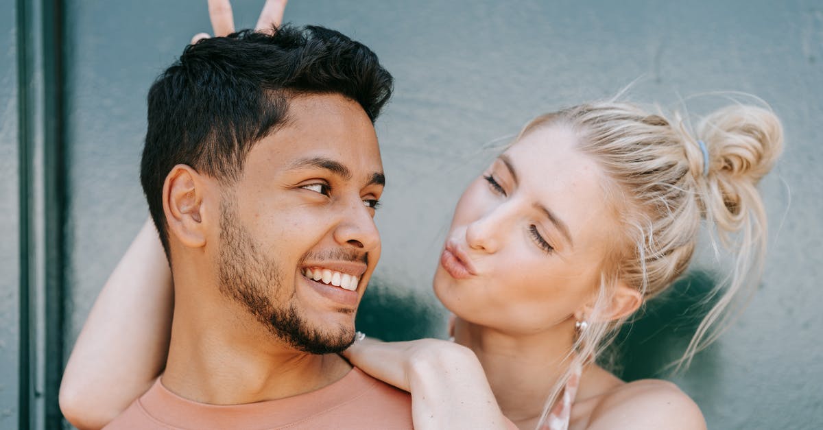 Do horns affect AI? - Man and Woman Smiling on the Beach