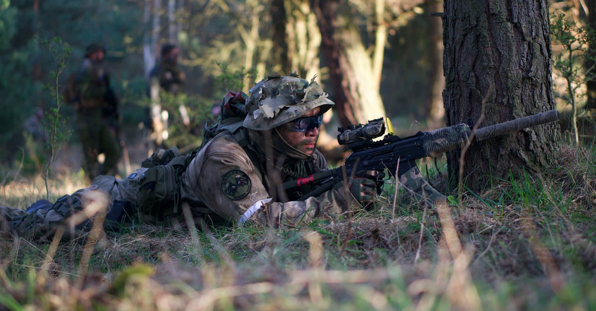 Do my dying soldiers live if I end the mission before stabilizing them? - Man in Camouflage Jacket Lying on Green Grass Field Do my dying soldiers live if I end the mission before stabilizing them? - Man in Camouflage Jacket Lying on Green Grass Field