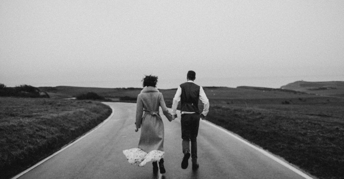 Do you run slower backwards or sideways? - Grayscale Photo of Couple Walking on Road