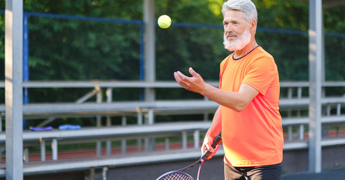 Does age matter when it comes to tennis skills? - Focused elderly man playing tennis on street