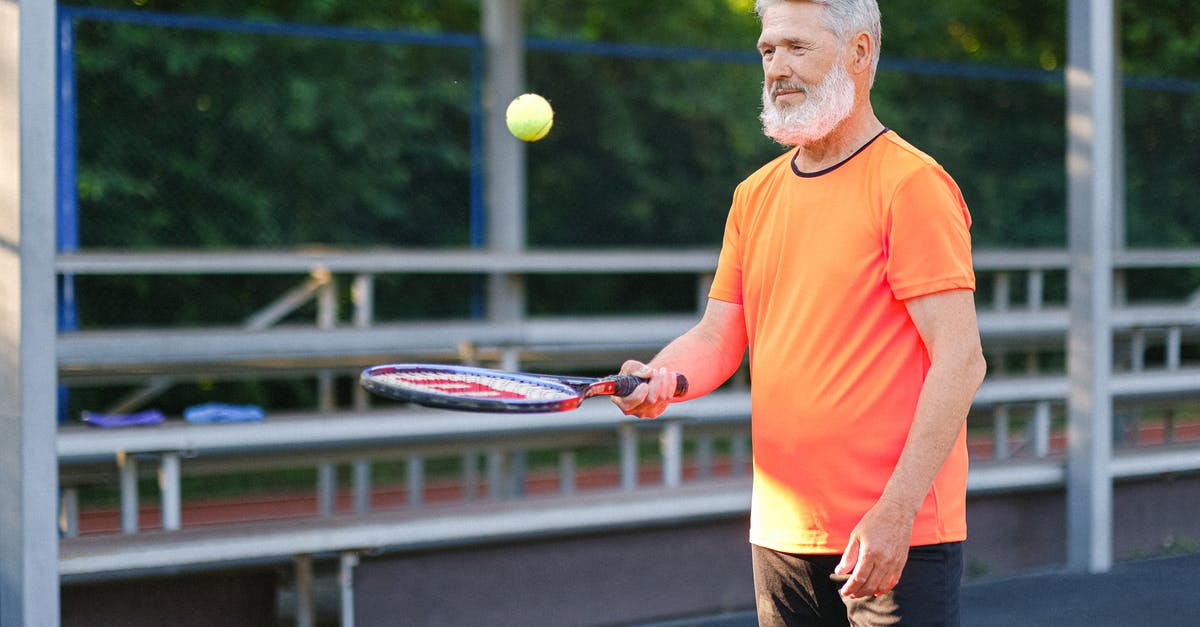 Does age matter when it comes to tennis skills? - Cheerful aged sportsman playing tennis on tennis court