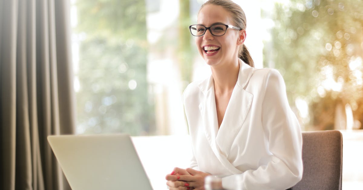 Does cannibalism satisfy hunger? - Laughing businesswoman working in office with laptop