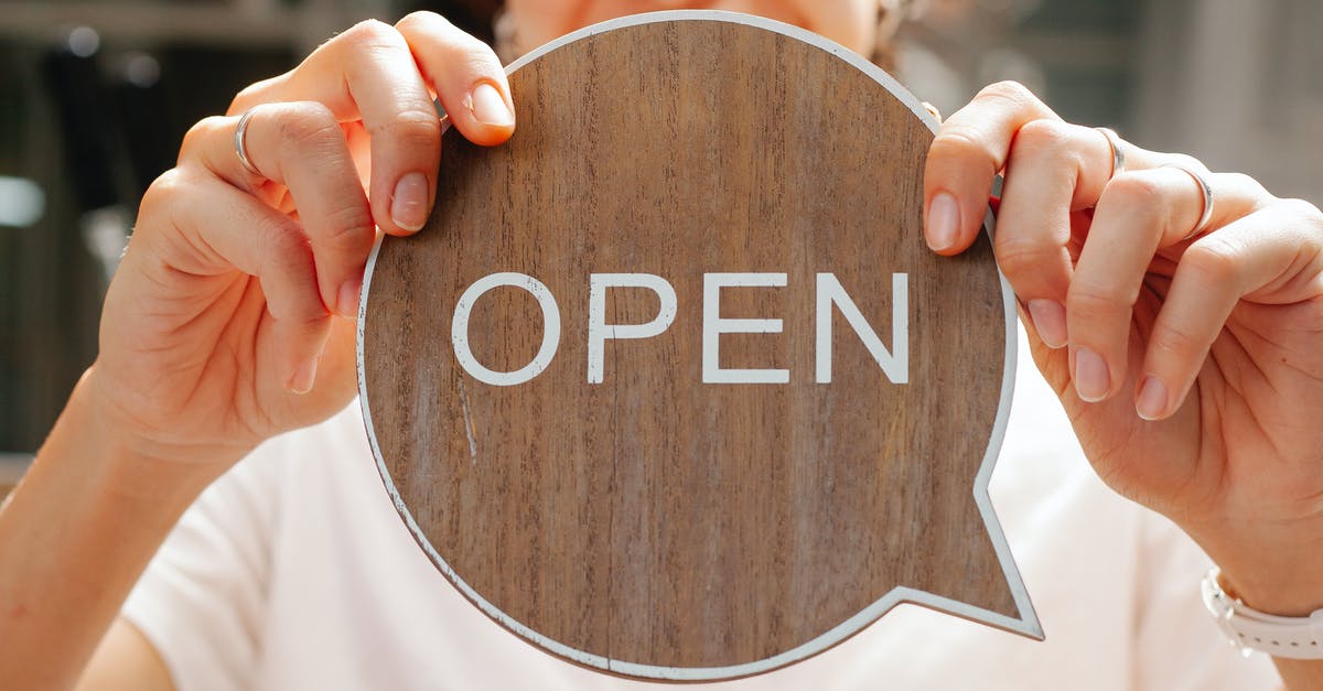 Does cannibalism satisfy hunger? - Happy woman showing wooden signboard saying open