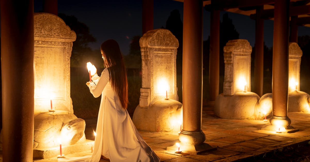 Does Dark Souls III follow Dark Souls and Dark Souls II in the storyline? - Full body back view of anonymous female with burning candles standing on knees near stone turtles while praying in dark time Does Dark Souls III follow Dark Souls and Dark Souls II in the storyline? - Full body back view of anonymous female with burning candles standing on knees near stone turtles while praying in dark time