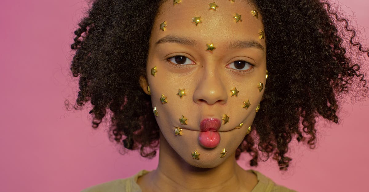 Does Darth Vader's punishing grip star card, make his choke do more damage? - Young African American female with yellow star rhinestones on face looking at camera while making fish lips on pink background