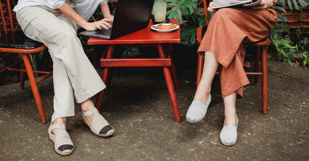 Does Evolve use horizontal or vertical FOV? - Crop anonymous female using laptop and sitting near friend reading magazine on terrace of cafe in daytime