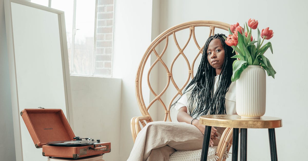 Does fresh start reset combat record? - Ethnic woman sitting in armchair near vinyl record player and vase of fresh flowers