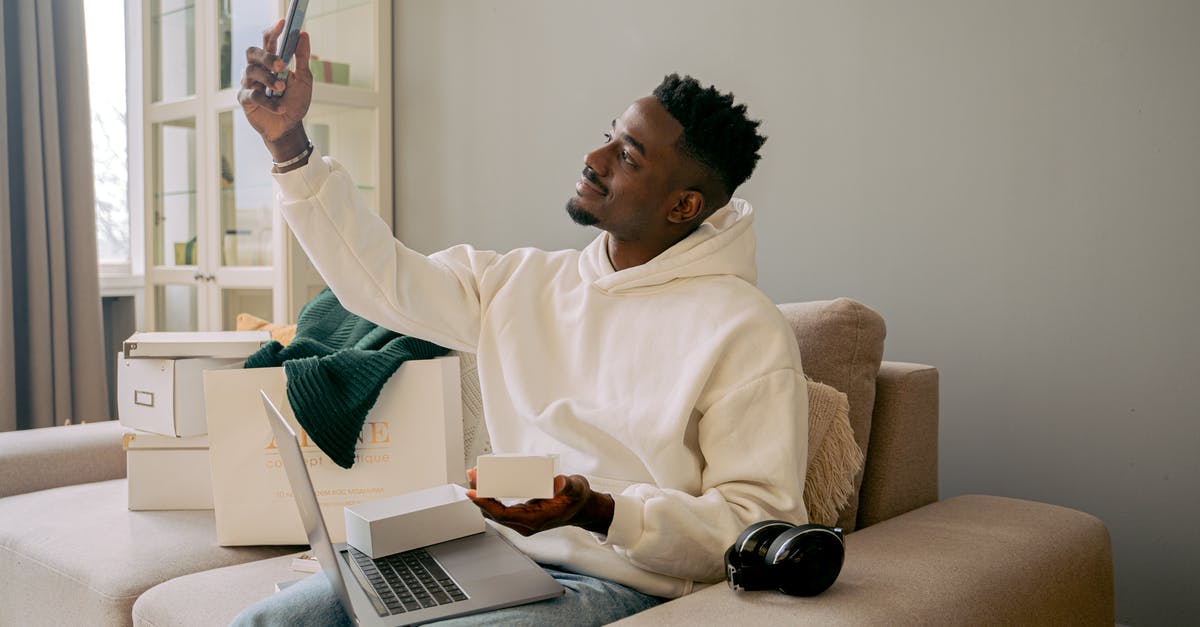 Does it matter if I bought something on the wrong account? - Man in White Sweater Sitting on Brown Sofa Chair