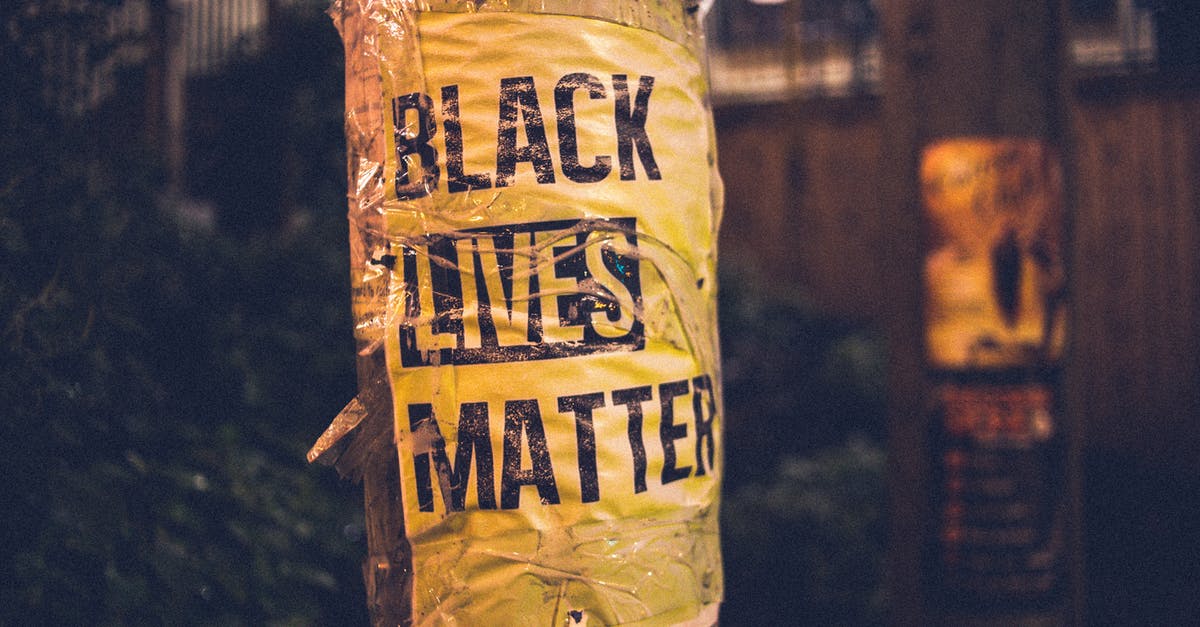 Does killing civilians increase the difficulty of the police response? - Inscription of protest movement saying black lives matter on pole in city street in evening