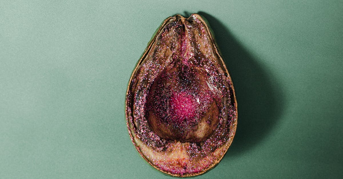 Does Nova spoil Legacy? - From above of half of rotten avocado covered with pink glitter placed on green background in studio
