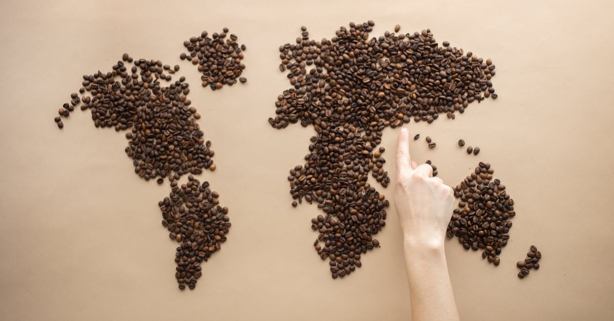 Does Reaper contest the point in his Wraith-form? - Top view of crop person pointing finger at world map made of coffee beans on brown background