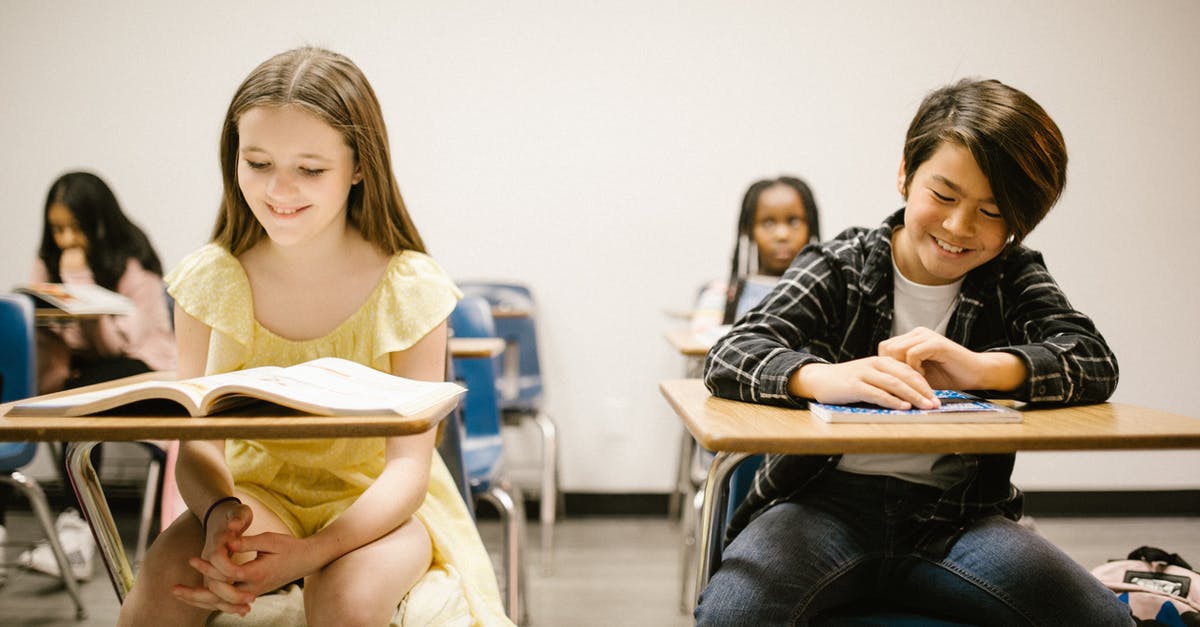 Does Sidewinder have an ending? - Two Students Smiling While Sitting on Their Desk