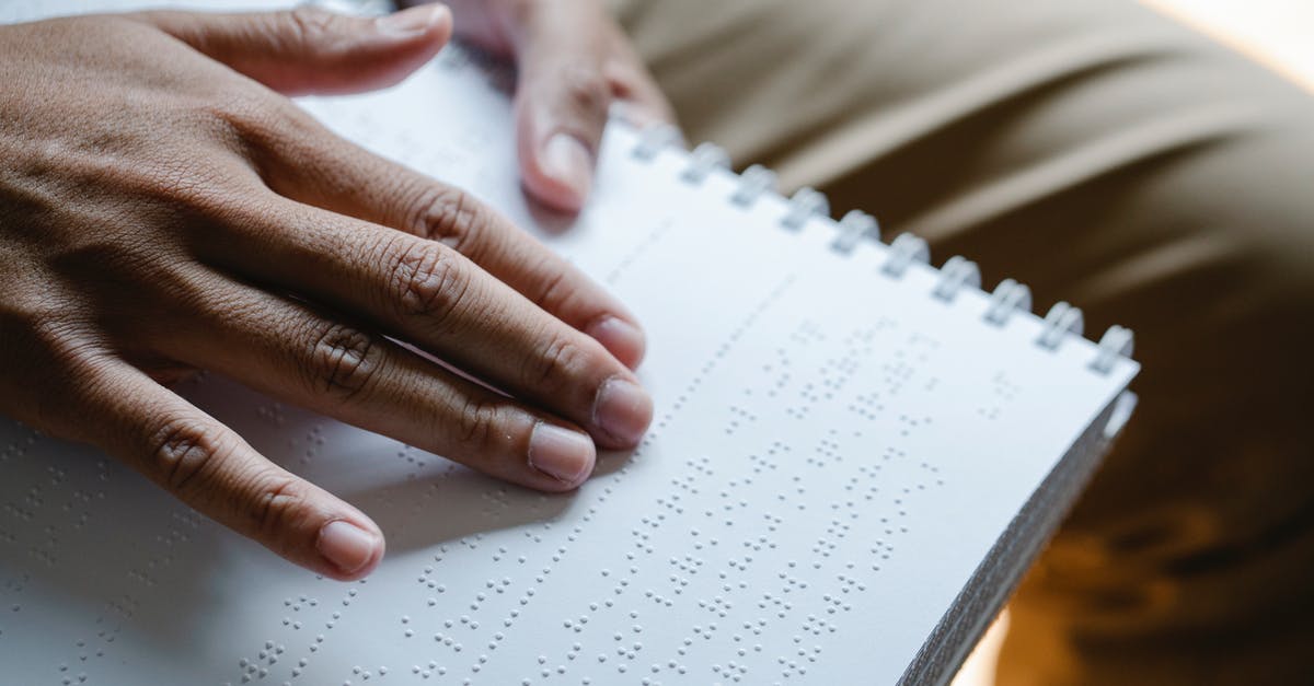 Does stun from artillery disable crew perks? - Closeup of crop unrecognizable blind person touching page with braille text while reading special book