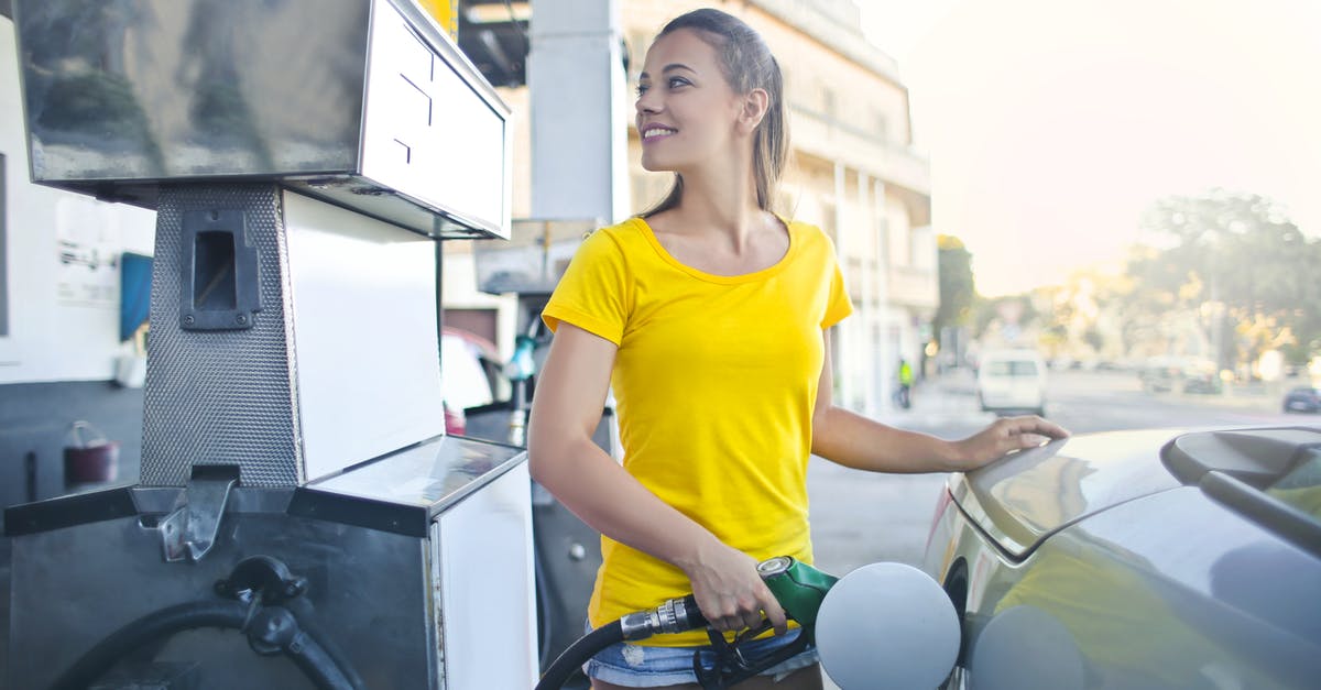 Does the amount of petrol affect your car's performance? - Woman in Yellow Shirt While Filling Up Her Car With Gasoline