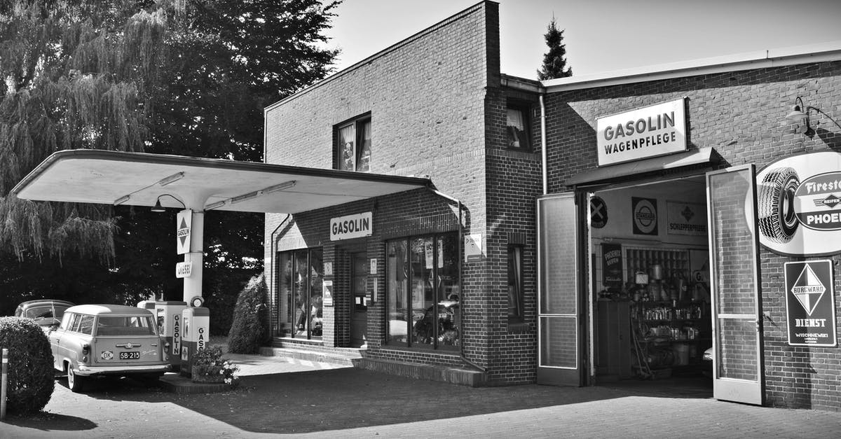 Does the amount of petrol affect your car's performance? - Gray Scale Photo of a Sedan Parked Infront of Store