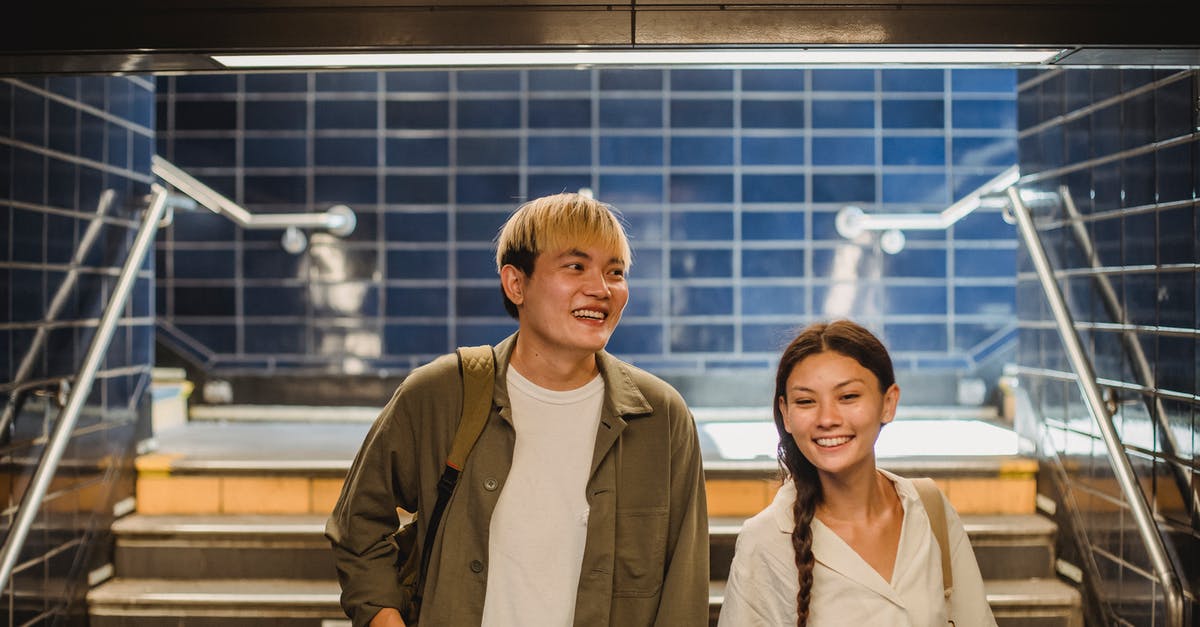 Does the expansion pass also affect the main game? - Happy Asian couple walking downstairs in underground walkway