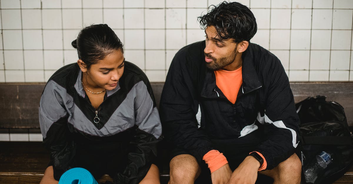 Does the HP of a Pokemon change after EV training it? - Two Young Sport People Resting after Fitness Exercises in Changing Room