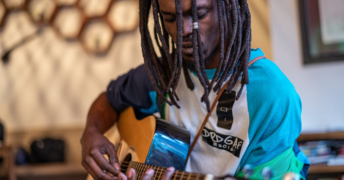 Does the In Rhythm talent stack with itself? - Focused black man playing guitar in studio