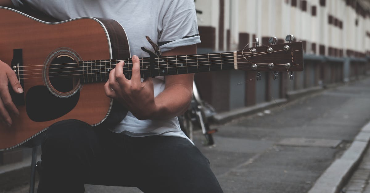 Does the In Rhythm talent stack with itself? - Crop guitarist playing on street