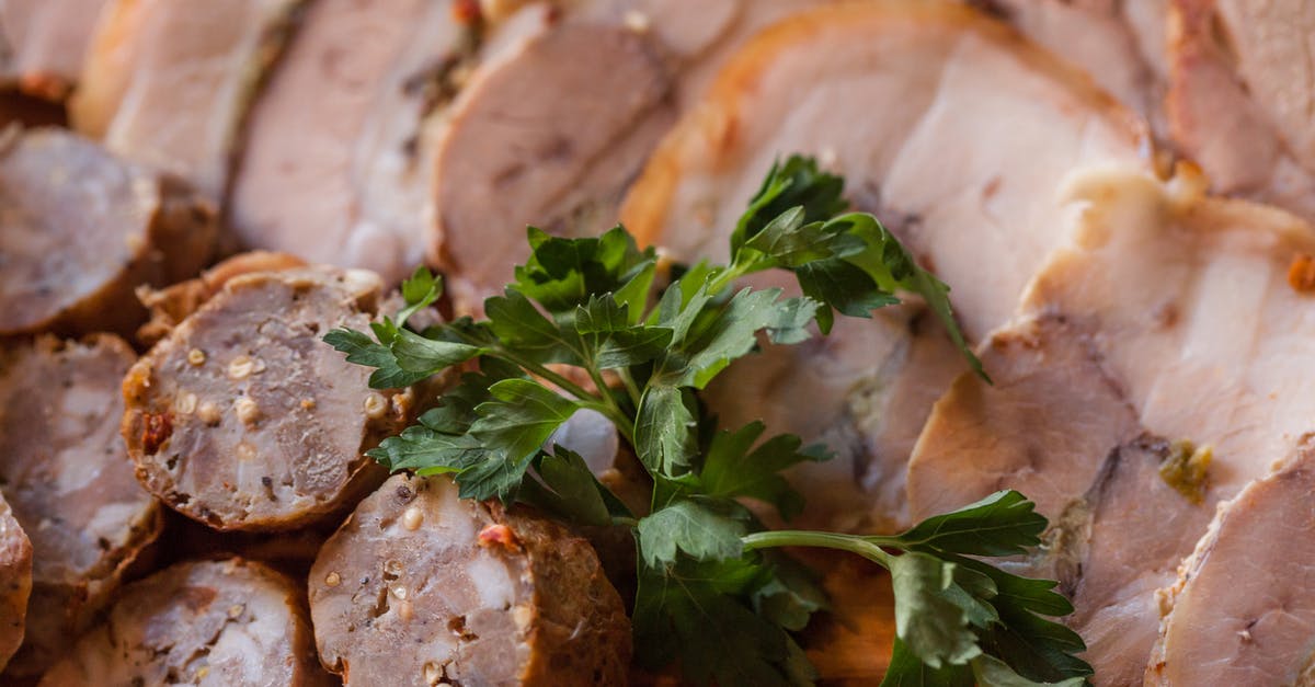 Does what I eat affect how fat I grow? - From above of tasty sliced sausage and meat placed on plate in daytime