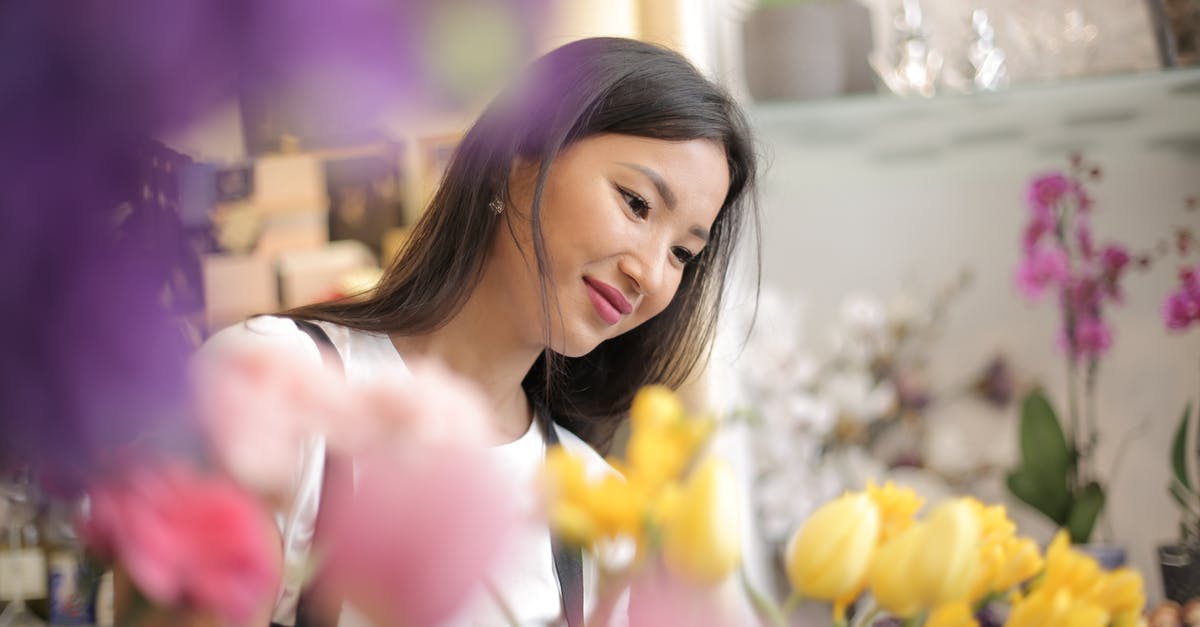 Doom (1993) with surround sound? - Satisfied smiling Asian female florist wearing apron surrounded by fresh colorful flowers and home plants during work in flower shop waiting for clients while looking down