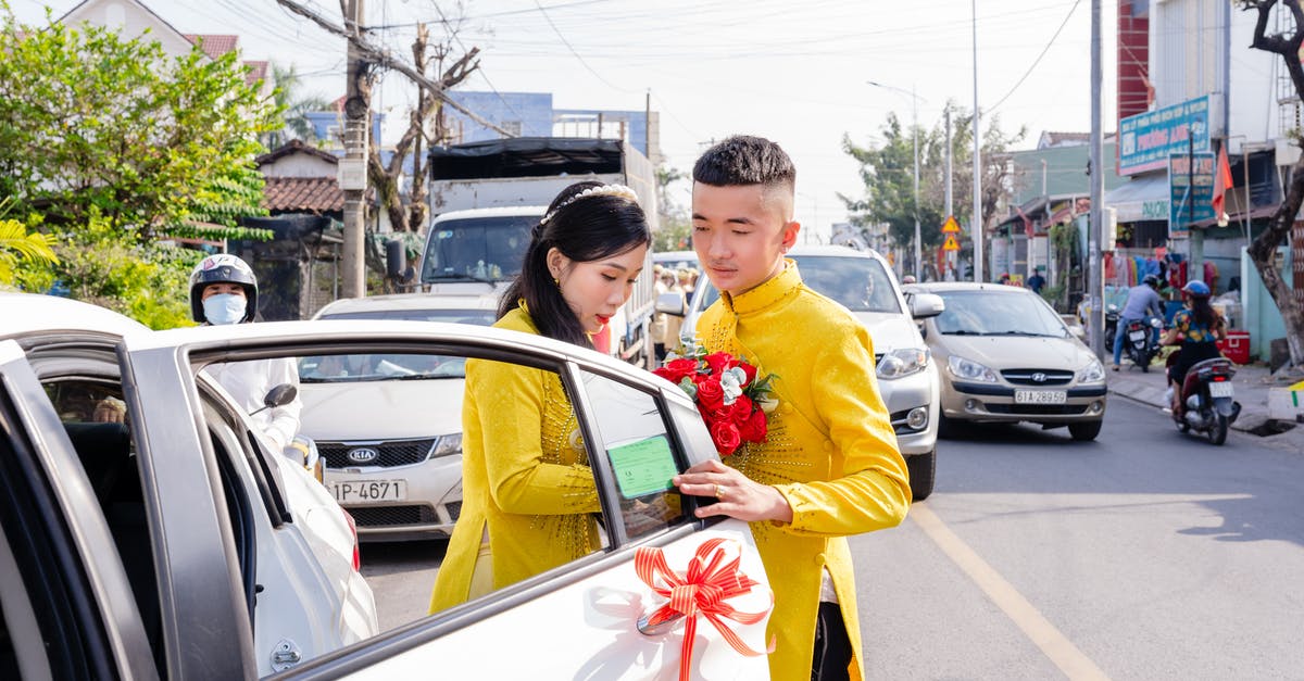 Dosbox gets muted when not focused - Man in Yellow Long Sleeve Shirt Holding Red and Yellow Flag Standing Beside White Car during