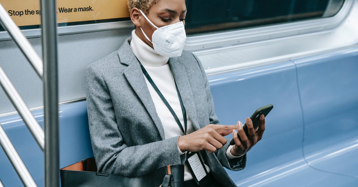 Dragon riding tamed Wolf problem - Crop black focused woman using smartphone in metro train