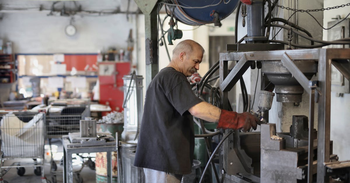 Efficient use of Construction Robots - Elderly white hair worker using machine