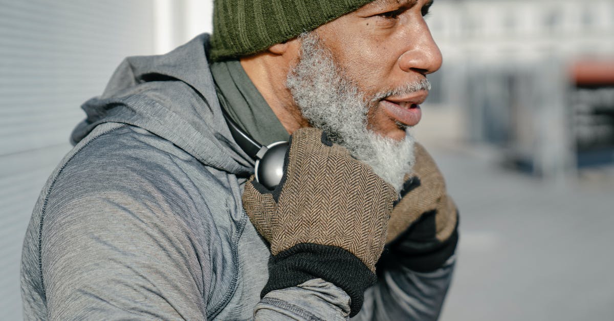 Elder Scrolls lore - Godhead in existing dream possible? Recursive dreaming? - Side view of bearded elderly African American male in green knitted hat wit headphones on neck looking away