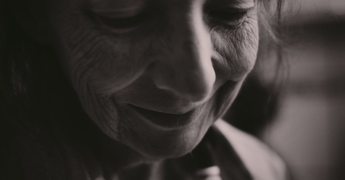 Elder Scrolls lore - Godhead in existing dream possible? Recursive dreaming? - Black and white closeup of crop smiling senior female face with closed eyes