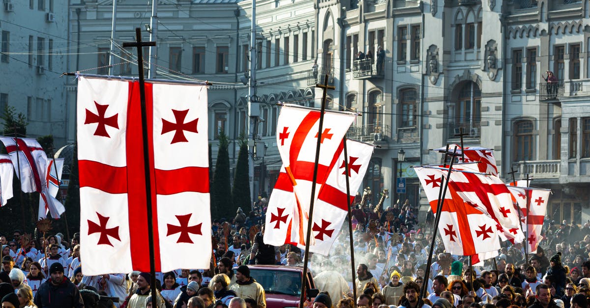 Enforcing Culture on Personal Union - Crowd of people waving flags of Georgia during celebration of religious holiday on Christmas day in Tbilisi