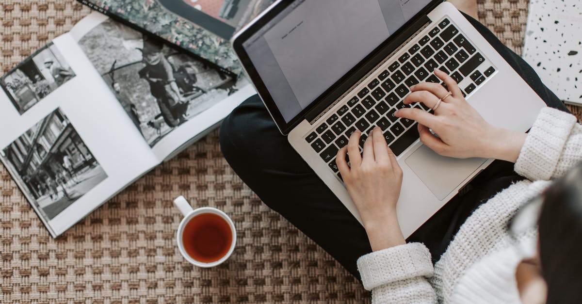 Escape from LeChuck's fortress without using grog? - Crop young businesswoman using laptop while drinking tea at home