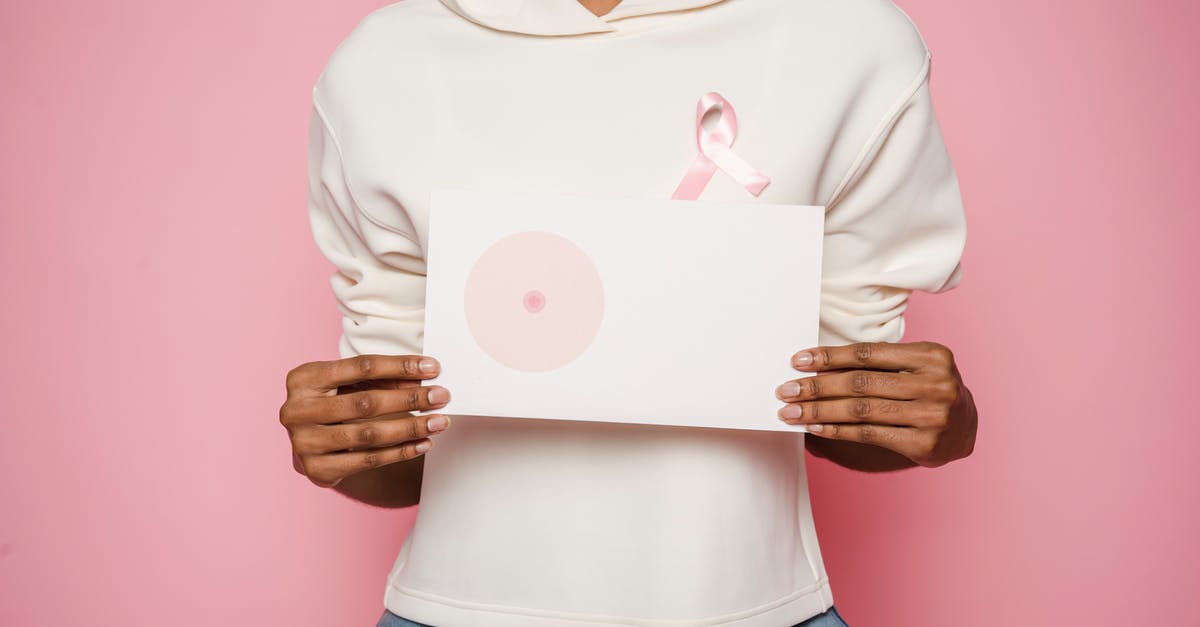 Event Campaigns and Grand Prize - Black female holding paper with painted one breast as symbol of cancer