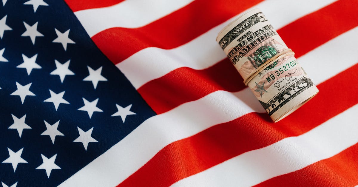 Everdrive save states, how is it possible? - From above of United States currency folded in roll placed on USA flag illustrating concept of business profit and wealth