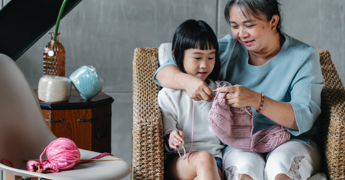 Exp. Share and Pokérus in second generation (GSC) - Loving Asian grandmother teaching little charming girl to knit spending time together at home