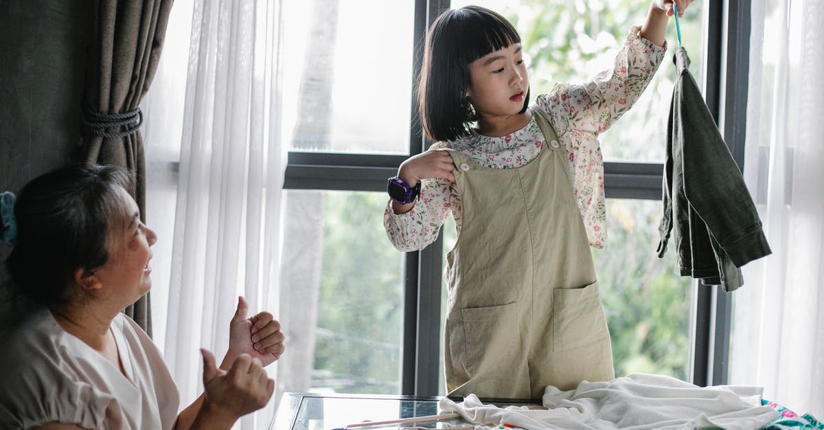 Expression2 Help Request: Rotating an entity on one axis - Happy Asian woman showing like gesture while granddaughter organizing clothes on hanger at home